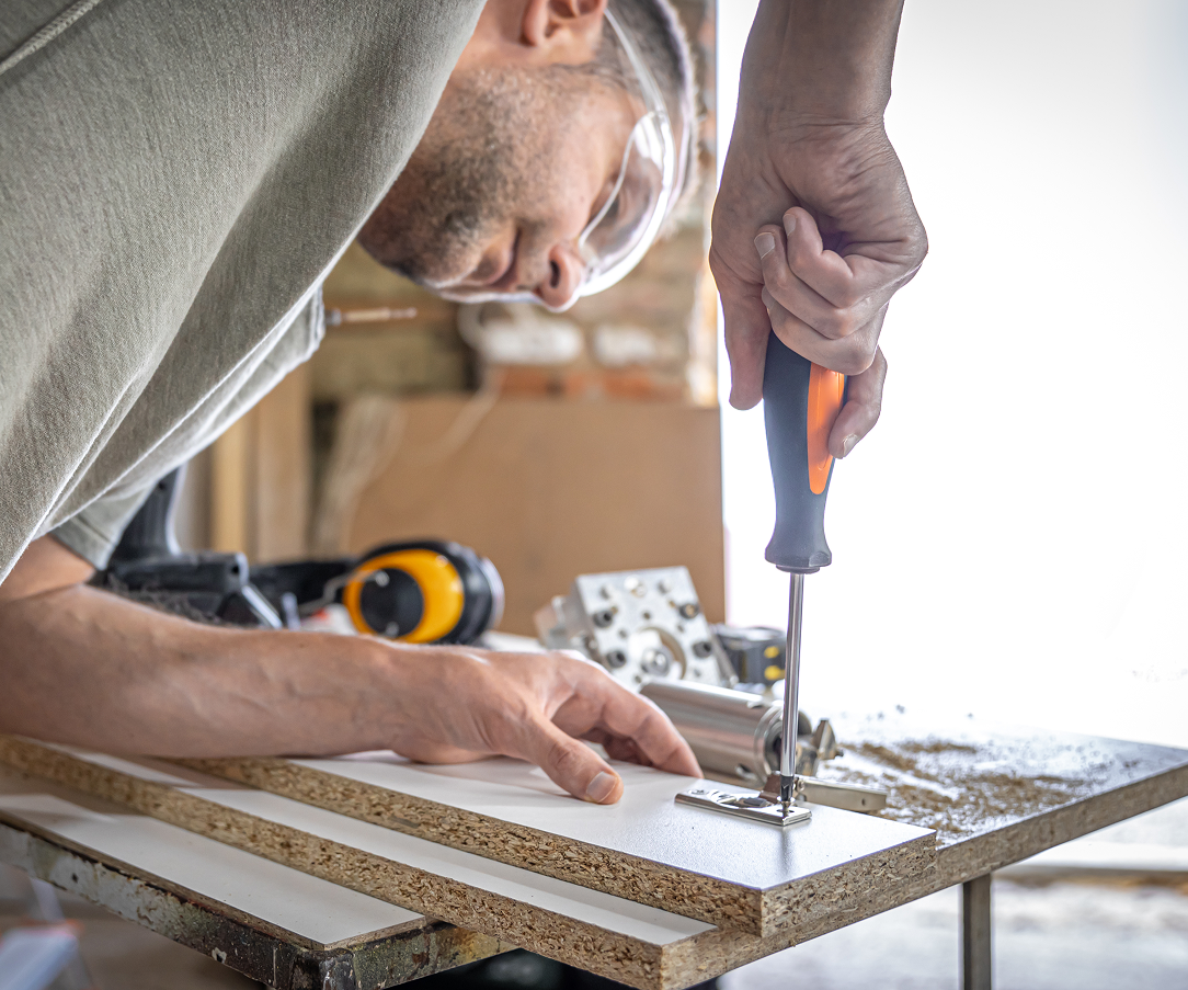 screwing-self-tapping-screw-into-metal-fastening-hole-wood-strip-using-screwdriver-work-carpenter 2