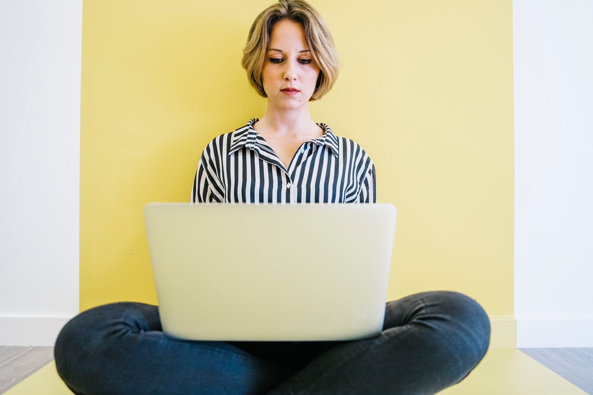 young-woman-browsing-laptop-floor young-woman-browsing-laptop-floor