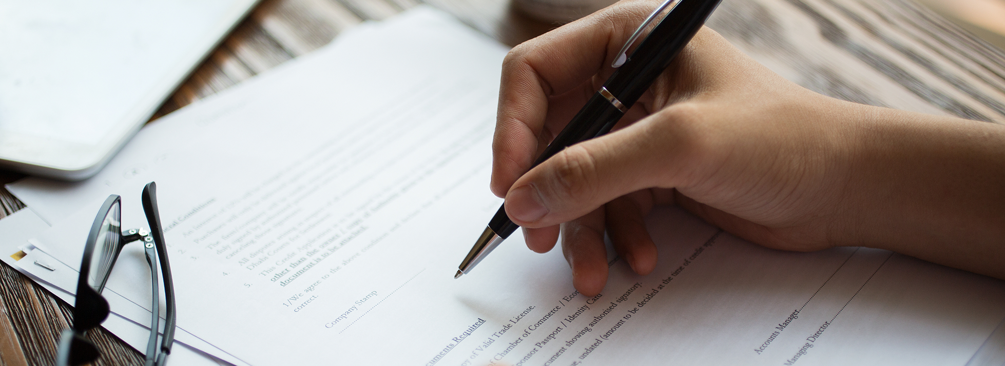 businessman-examining-papers-table 6 businessman-examining-papers-table 6
