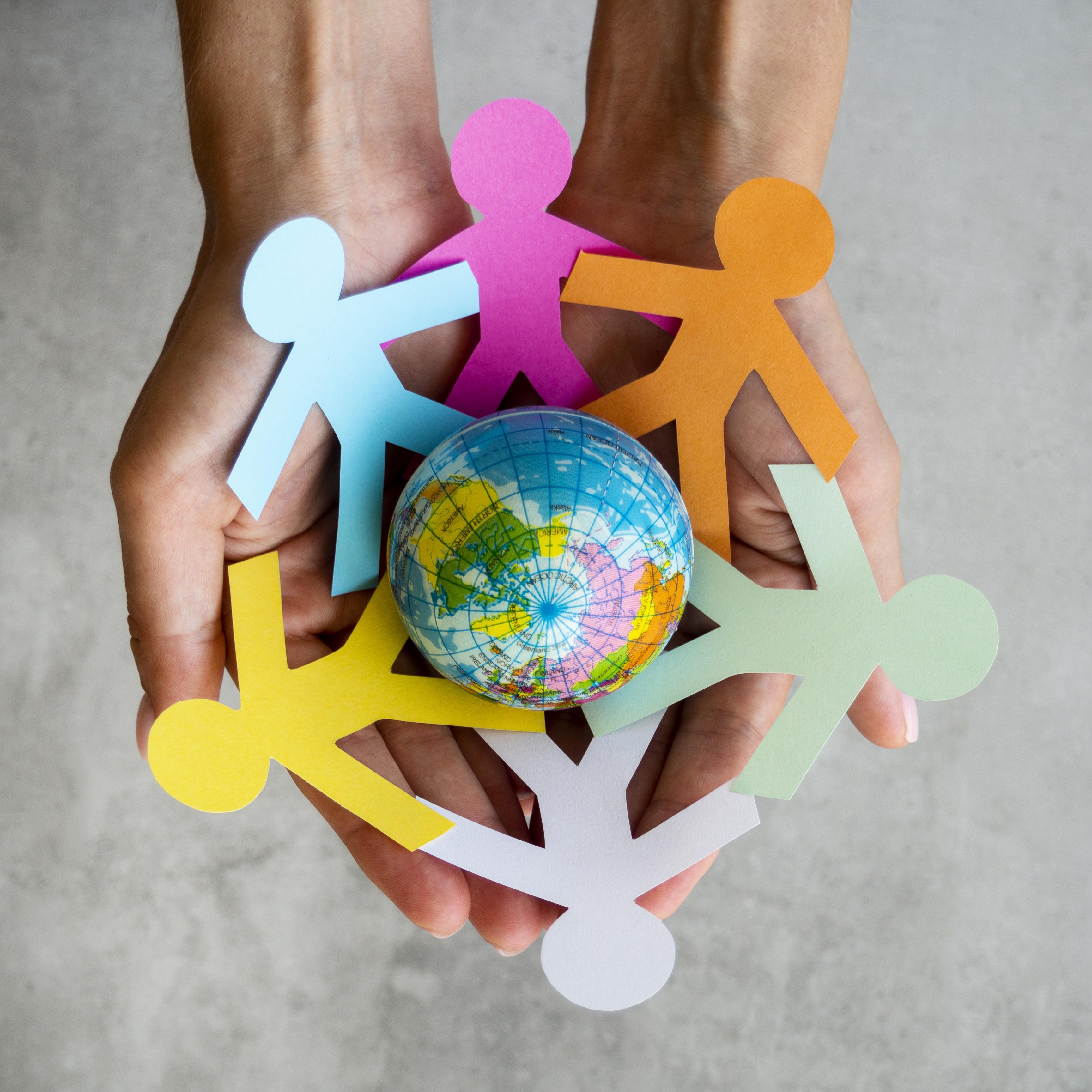 top-view-origami-chain-people-with-globe-1